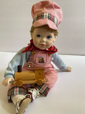 Danbury Mint Pink Conductor Doll with Plaid Trim and Wooden Train